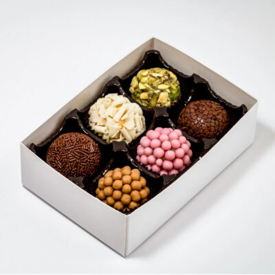 A six pack of Brigadeiros with various toppings and colours