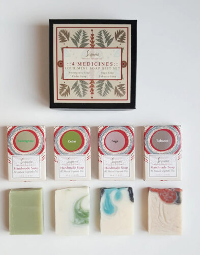 The sweetgrass, cedar, sage and tobacco soaps, beneath the black and patterned gift box